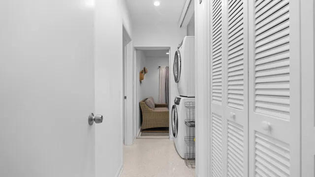 a view of a hallway with a livingroom and a bathroom