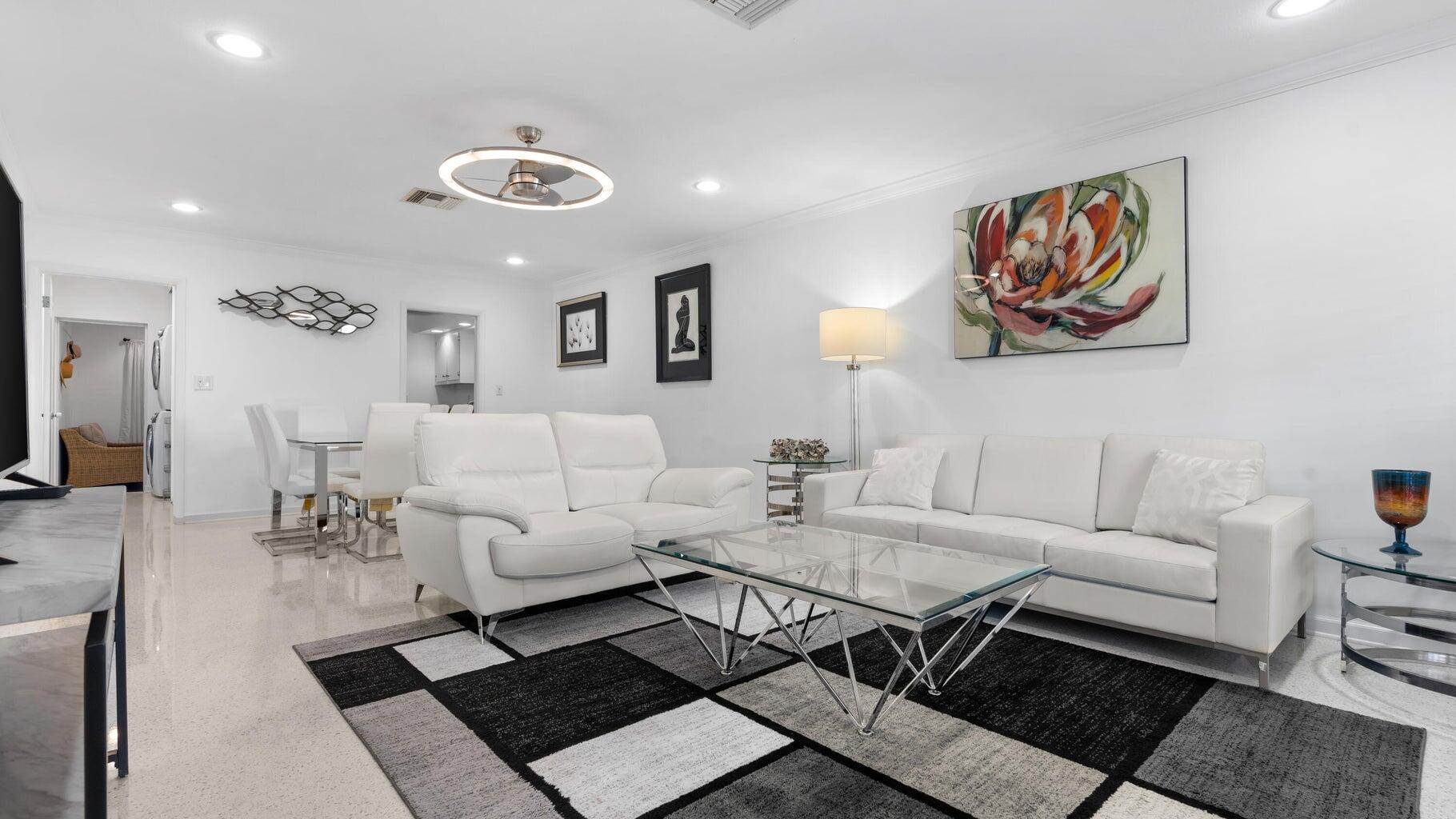 410 Venetian Drive Delray Beach, FL 33483 - Photo 23 of 28 a living room with furniture and a flat screen tv