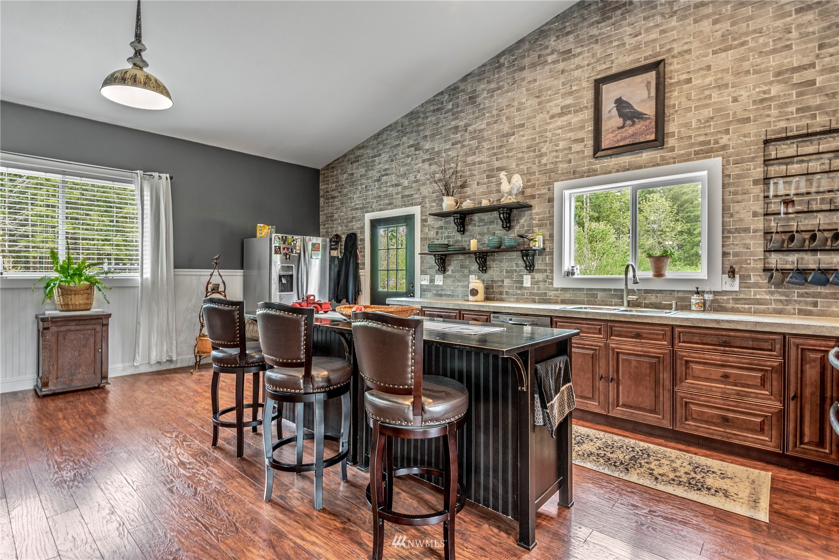 810 Logan Hill Road Chehalis, WA 98532 - Photo 12 of 39 a dining hall with stainless steel appliances granite countertop a stove a sink a dining table and chairs