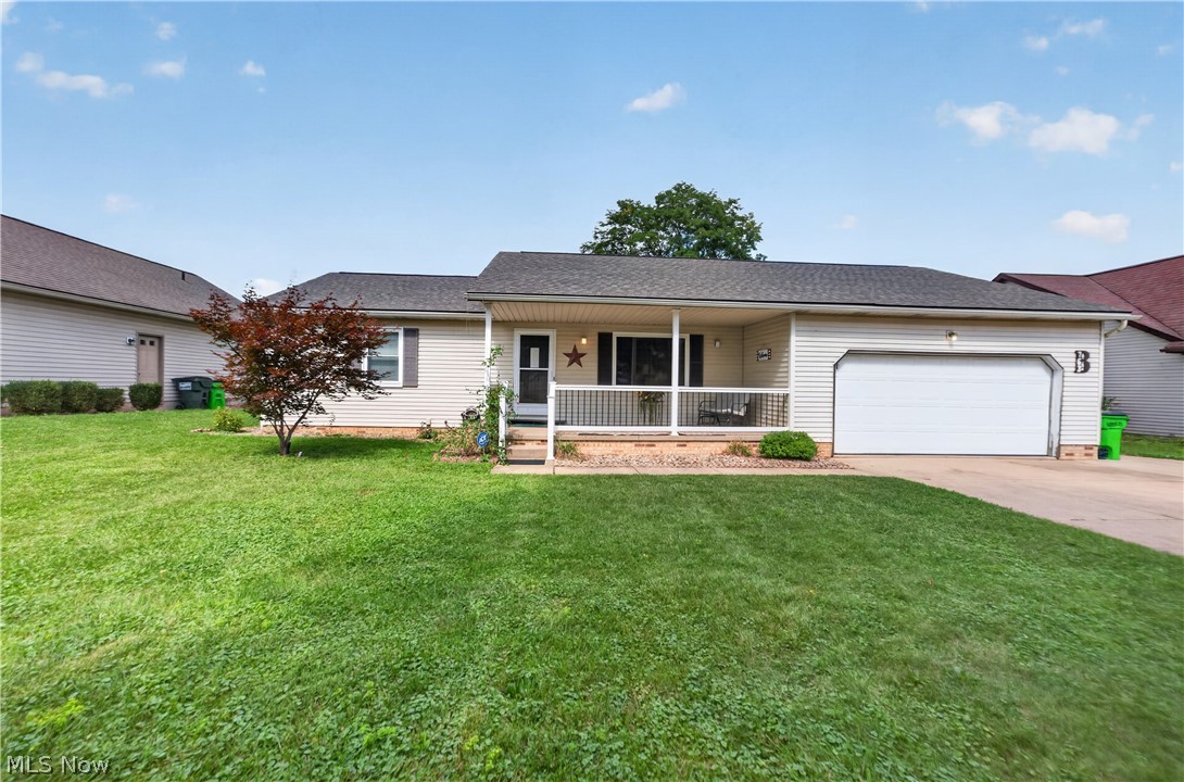 763 Lockwood Road Barberton, OH 44203 - Photo 1 of 24 Single-story residence featuring light-toned siding, an attached garage, a covered front porch, and a paved driveway