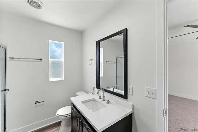 a bathroom with a tub sink and mirror