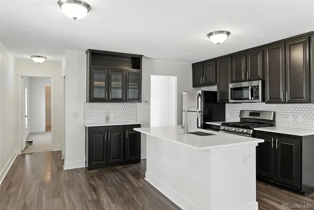a kitchen with granite countertop a stove and a sink