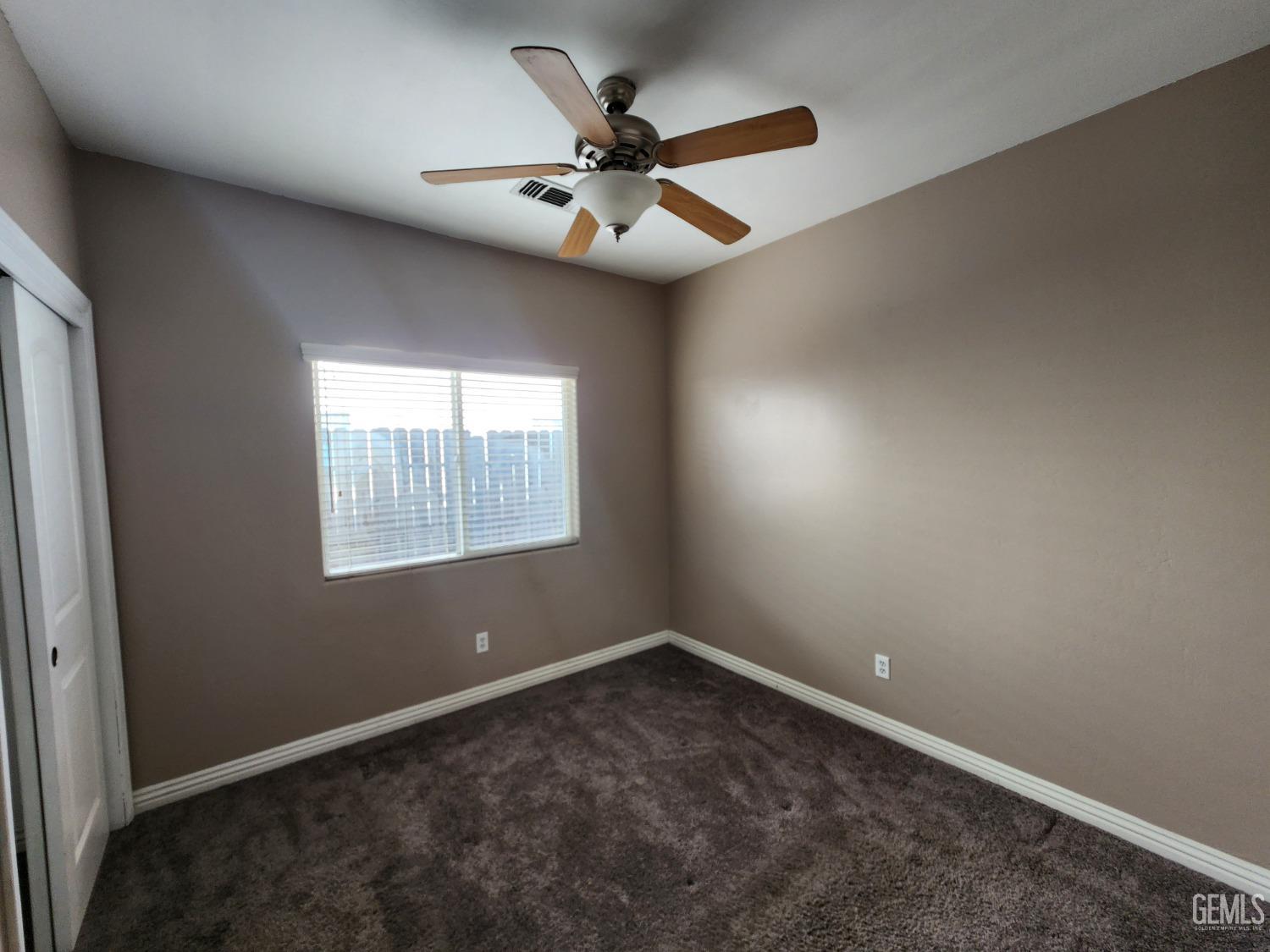 Undisclosed Address Bakersfield, CA 93313 - Photo 14 of 19 an empty room with window and ceiling fan