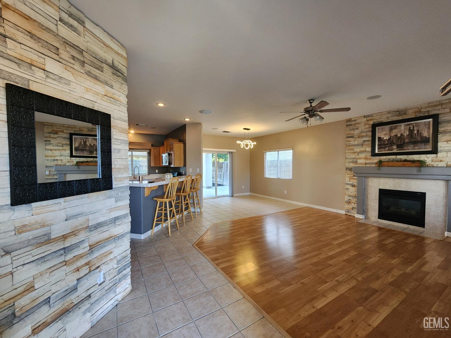 Undisclosed Address Bakersfield, CA 93313 - Photo 15 of 19 a view of a livingroom with kitchen and a fireplace