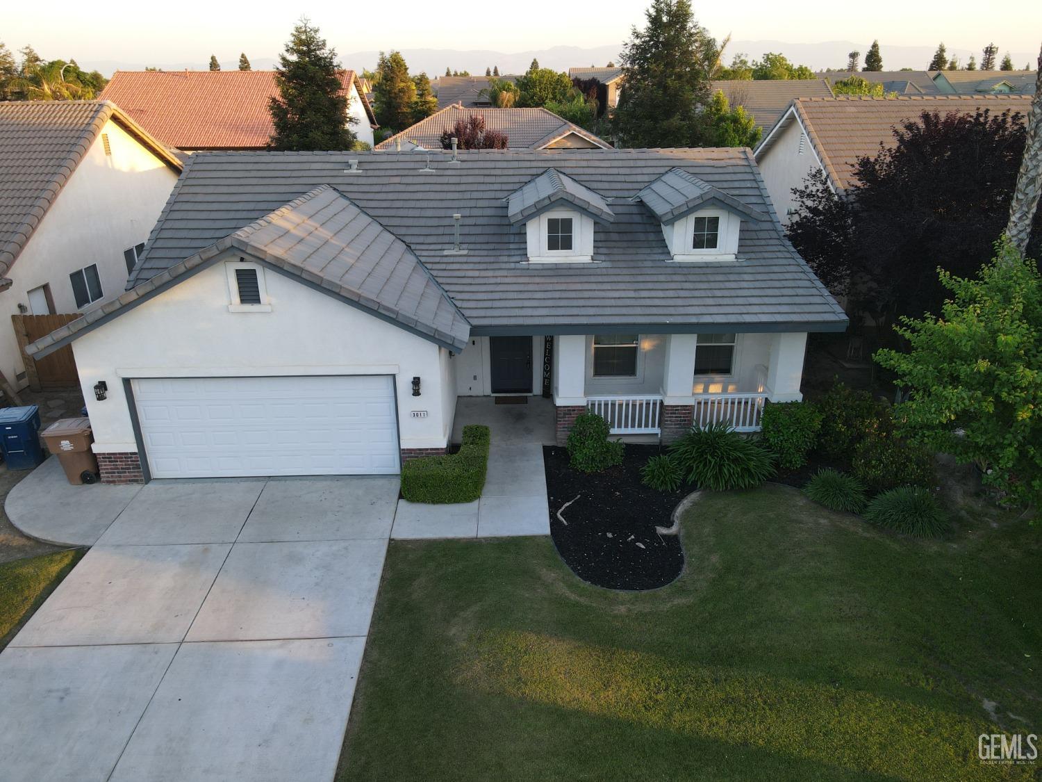Undisclosed Address Bakersfield, CA 93313 - Photo 19 of 19 a view of a house with a yard and a garden