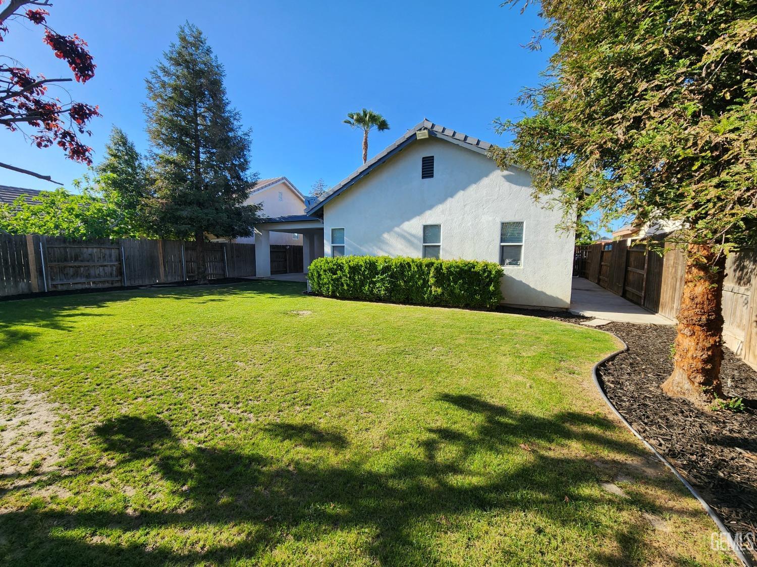 Undisclosed Address Bakersfield, CA 93313 - Photo 4 of 19 a view of a house with a yard patio and swimming pool