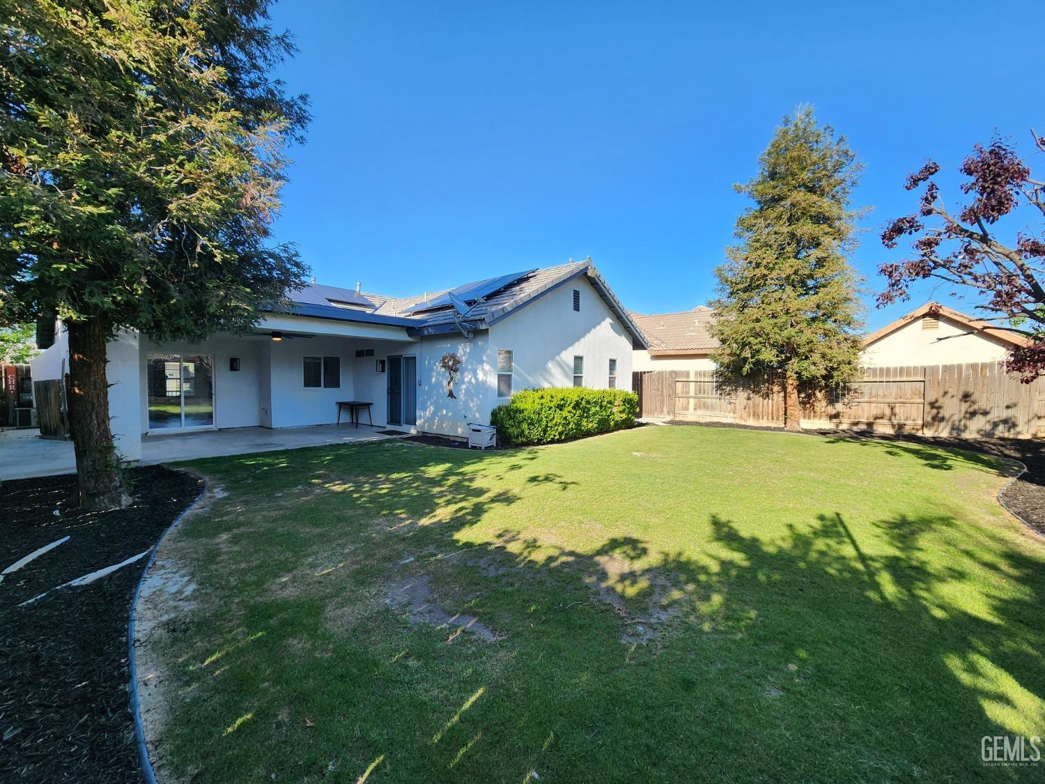 Undisclosed Address Bakersfield, CA 93313 - Photo 5 of 19 a view of a house with a yard patio and fire pit