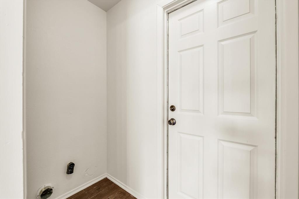 141 Travis Lane Hewitt, TX 76643 - Photo 23 of 31 Utility area with wood-finish flooring and a six-panel door