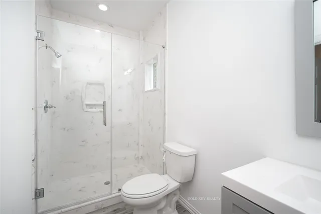 a white toilet sitting next to a bathroom sink