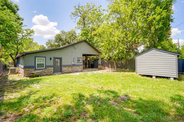 a view of a house with a yard and sitting area