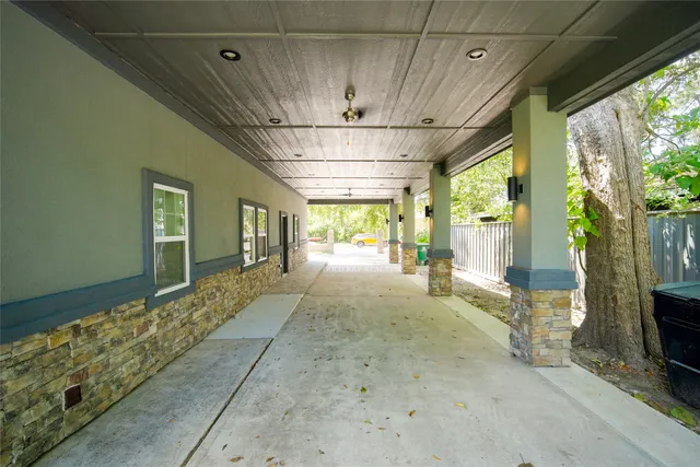 a view of a hallway with wooden floor and a fireplace