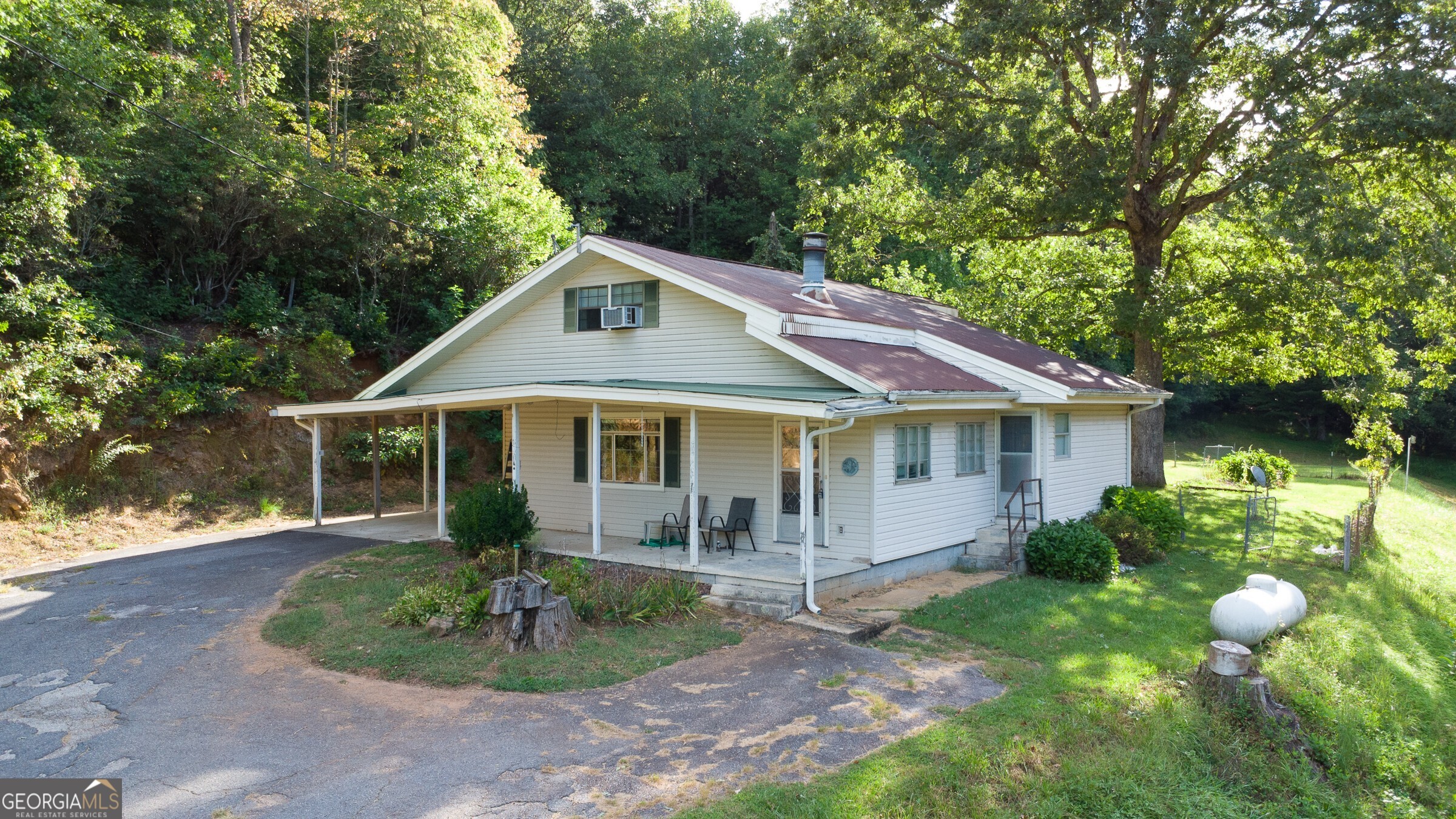 239 Glenn Elliott Road Dahlonega, GA 30533 - Photo 12 of 28 a front view of a house with a garden