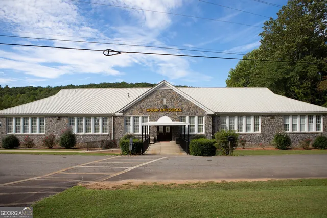 a house view with a garden space and wooden fence