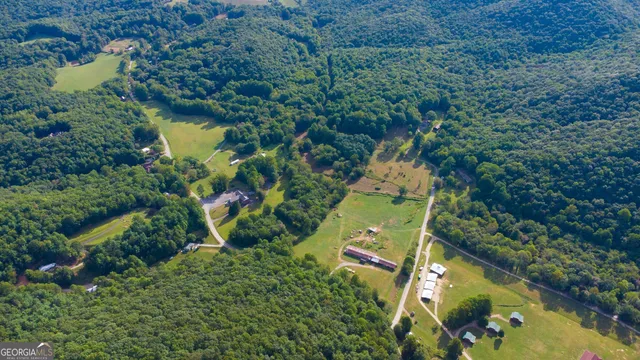 an aerial view of residential house with outdoor space and swimming pool