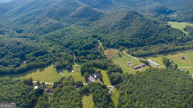 an aerial view of residential house with outdoor space and lake view