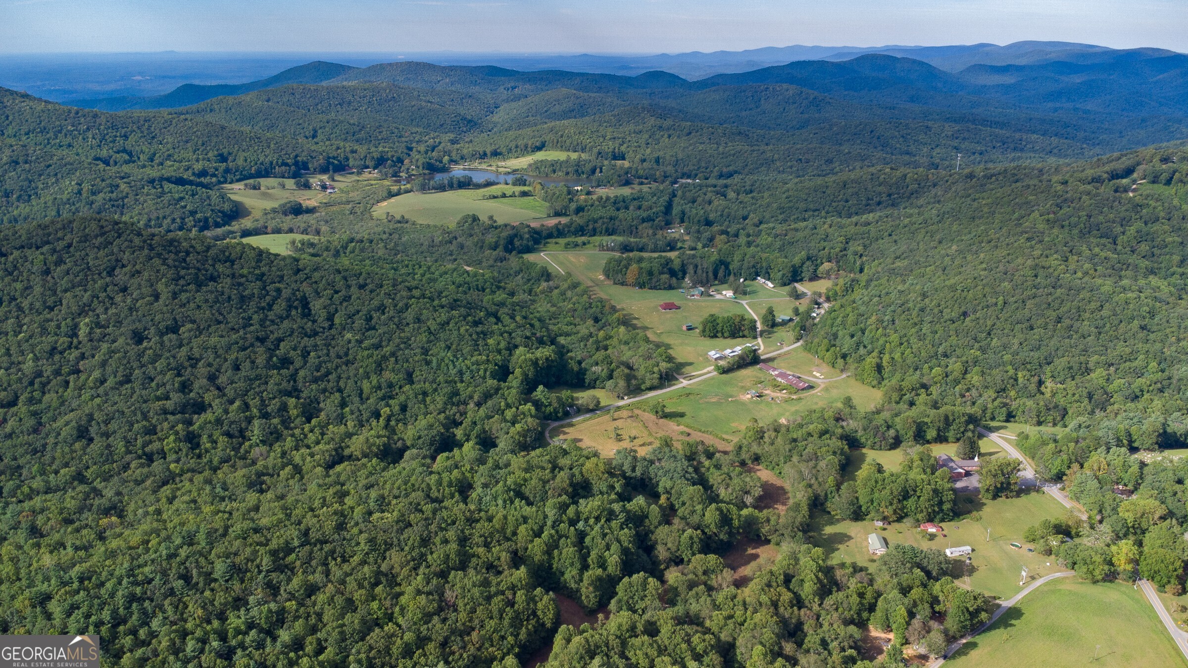 239 Glenn Elliott Road Dahlonega, GA 30533 - Photo 9 of 28 a view of a lush green hillside and a houses