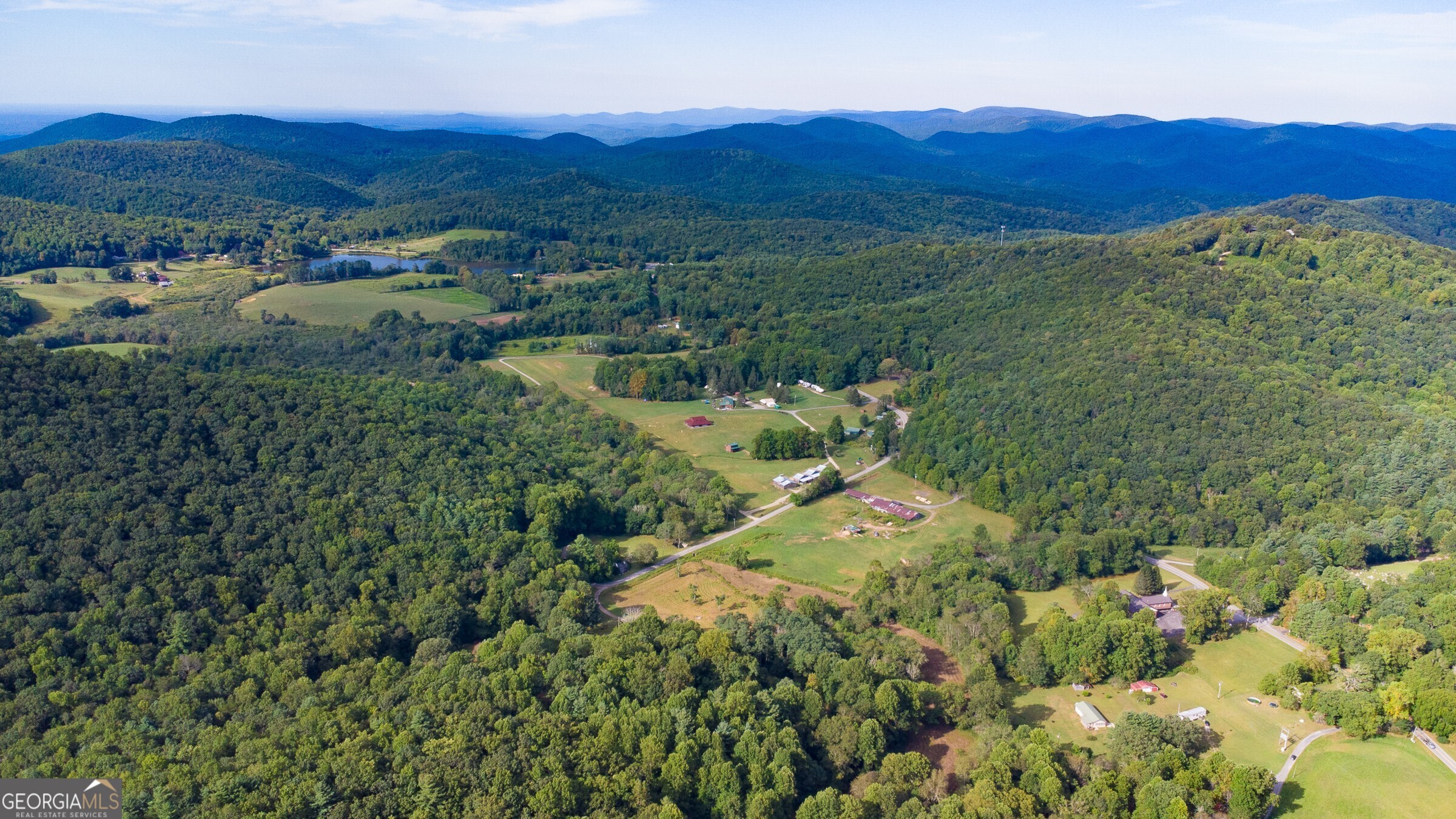 239 Glenn Elliott Road Dahlonega, GA 30533 - Photo 10 of 28 a view of a lush green hillside and houses