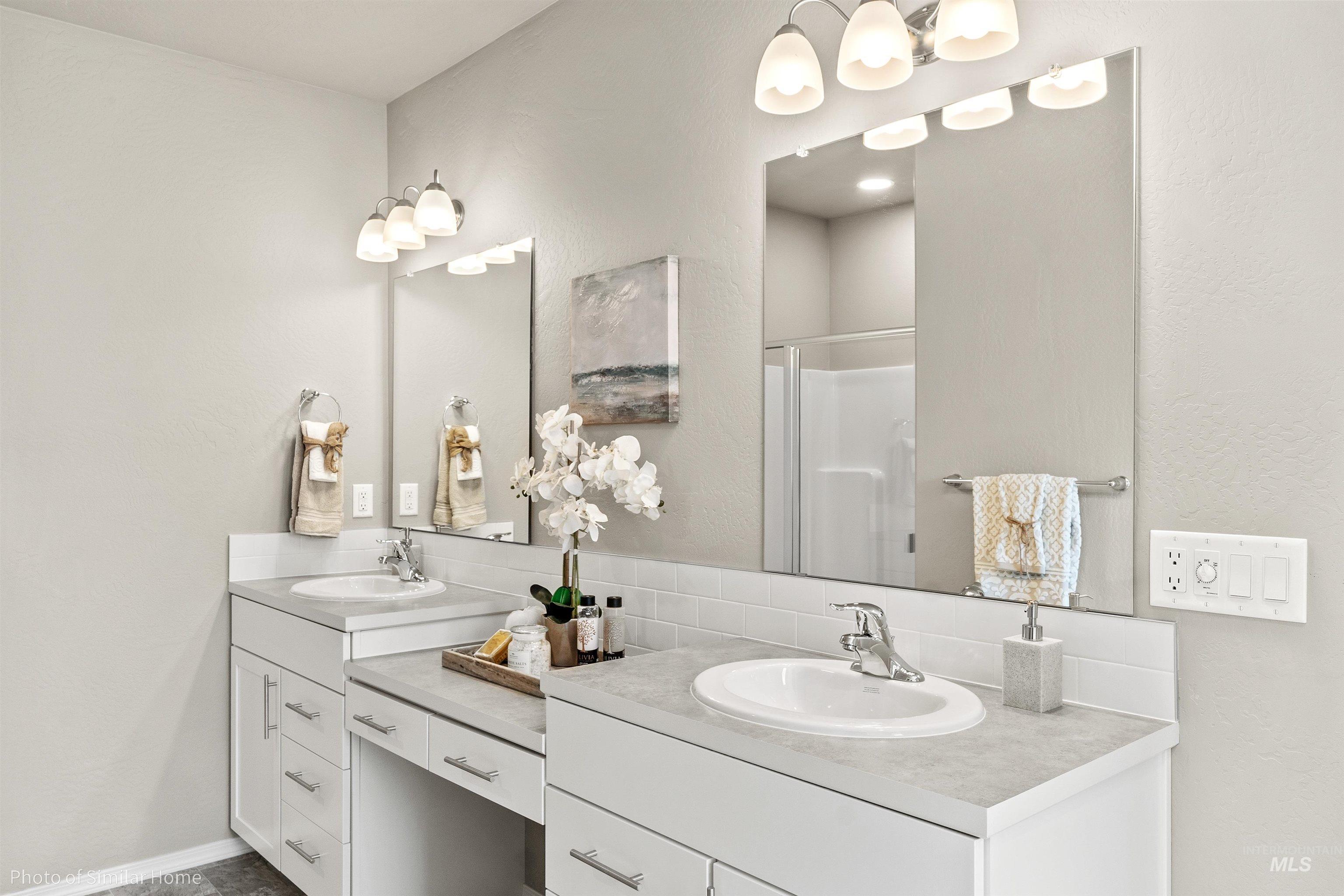382 West Gleason Court Meridian, ID 83646 - Photo 5 of 21 Bathroom with a stall shower, a textured wall, and double vanity