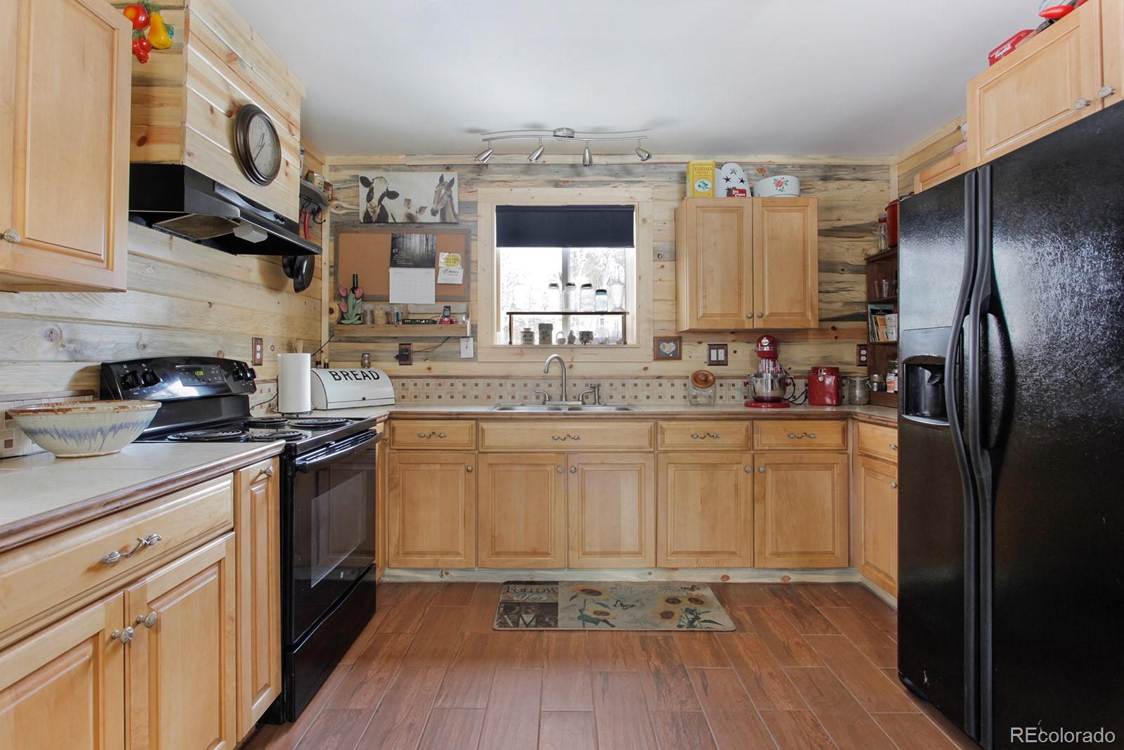 274 Buffum Street Bailey, CO 80421 - Photo 6 of 13 a kitchen with stainless steel appliances granite countertop a sink stove and refrigerator