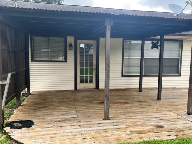 a view of a house with wooden floor and windows