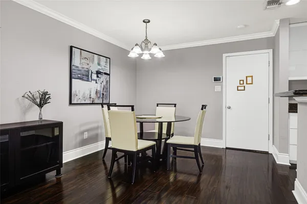 a view of a dining room with furniture wooden floor and a chandelier