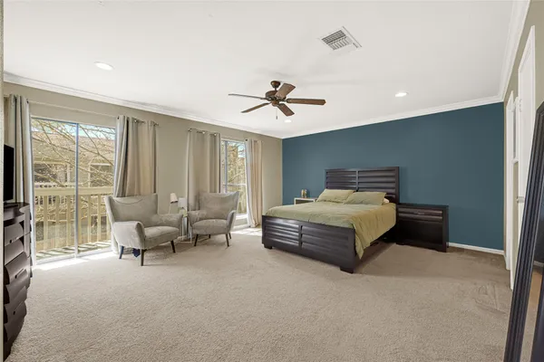 a bedroom with bed and glass door