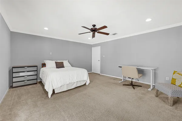 a bedroom with a bed and a ceiling fan