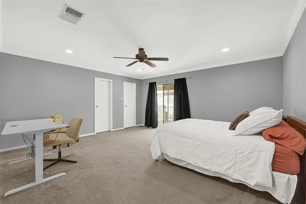 a bedroom with a bed and a chair