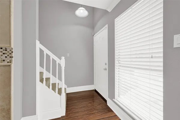 a view of an entryway with wooden floor