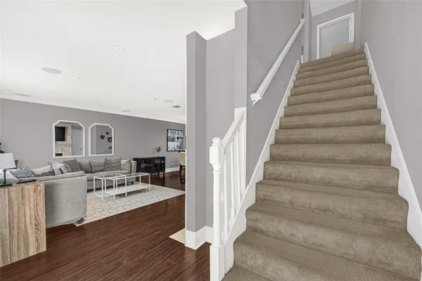 a room with lots of white furniture and entryway