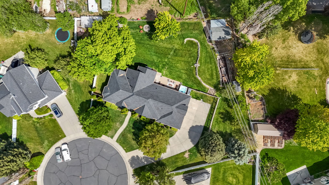 357 South 320 W Street Lindon, UT 84042 - Photo 41 of 41 Spacious property featuring a large house with a dark shingle roof, expansive green lawn, mature trees, and a concrete driveway