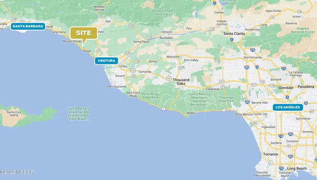 a view of a green field with an ocean view