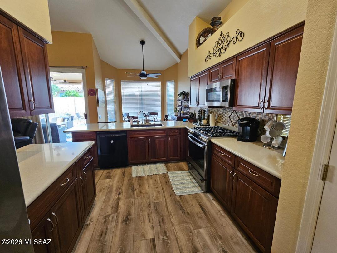 3130 West Star Ranch Trail Tucson, AZ 85742 - Photo 17 of 44 a large kitchen with stainless steel appliances sink a stove and cabinets