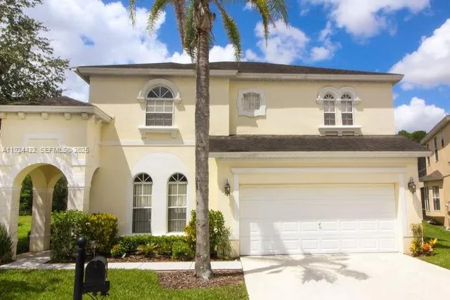 a front view of a house with garden