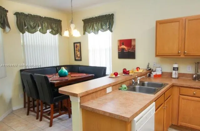 a kitchen with a sink cabinets and wooden floor