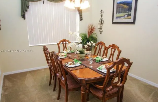a dining room with furniture and wooden floor