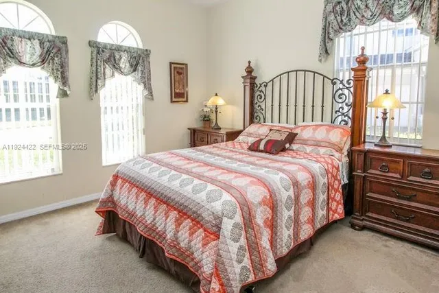 a bed sitting in a bedroom next to a window