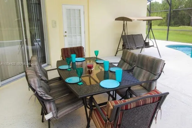 a dining room with furniture and a swimming pool