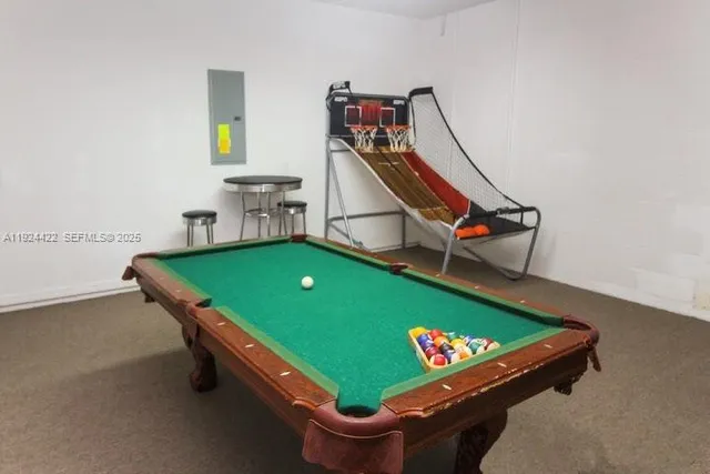 a room with pool table and windows