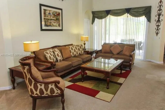 a living room with furniture and a large window