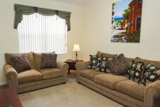 a living room with furniture and a large window