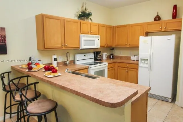 a kitchen with a sink a stove and a refrigerator
