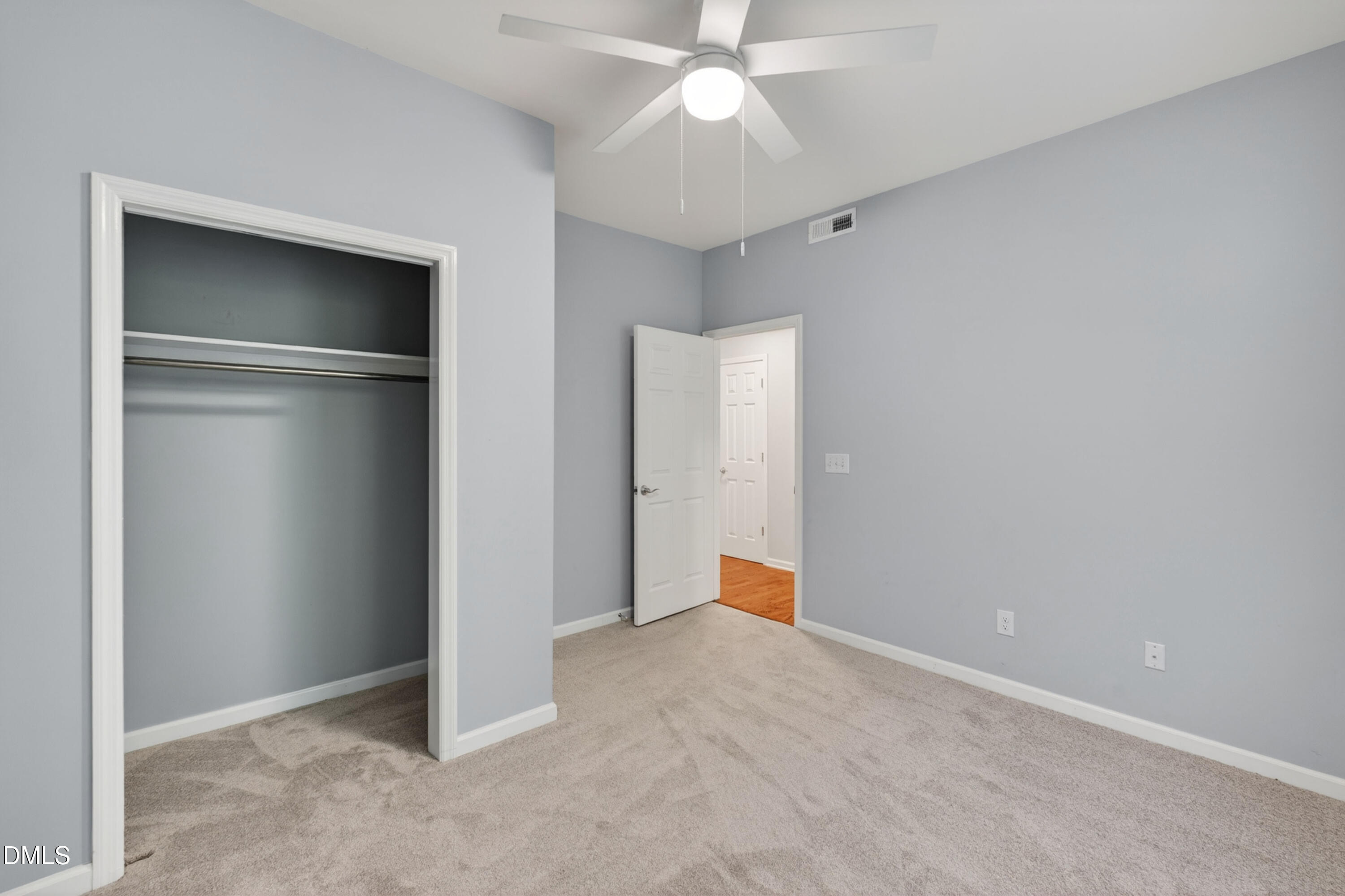 5421 Golden Arrow Lane Raleigh, NC 27613 - Photo 10 of 49 an empty room with closet and a chandelier fan