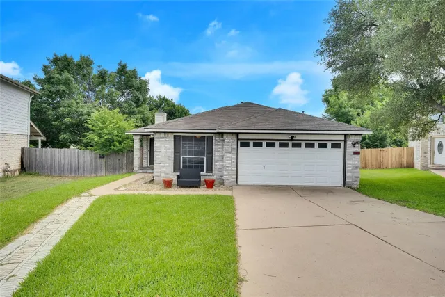 a view of a house with backyard and sitting area