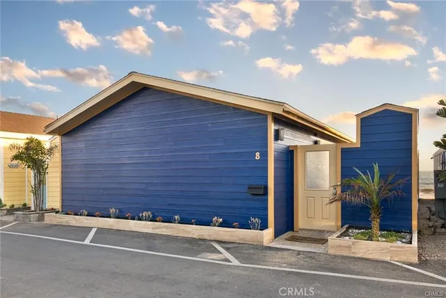 a view of a house with a wooden fence