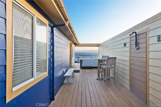 a balcony with chairs and wooden floor