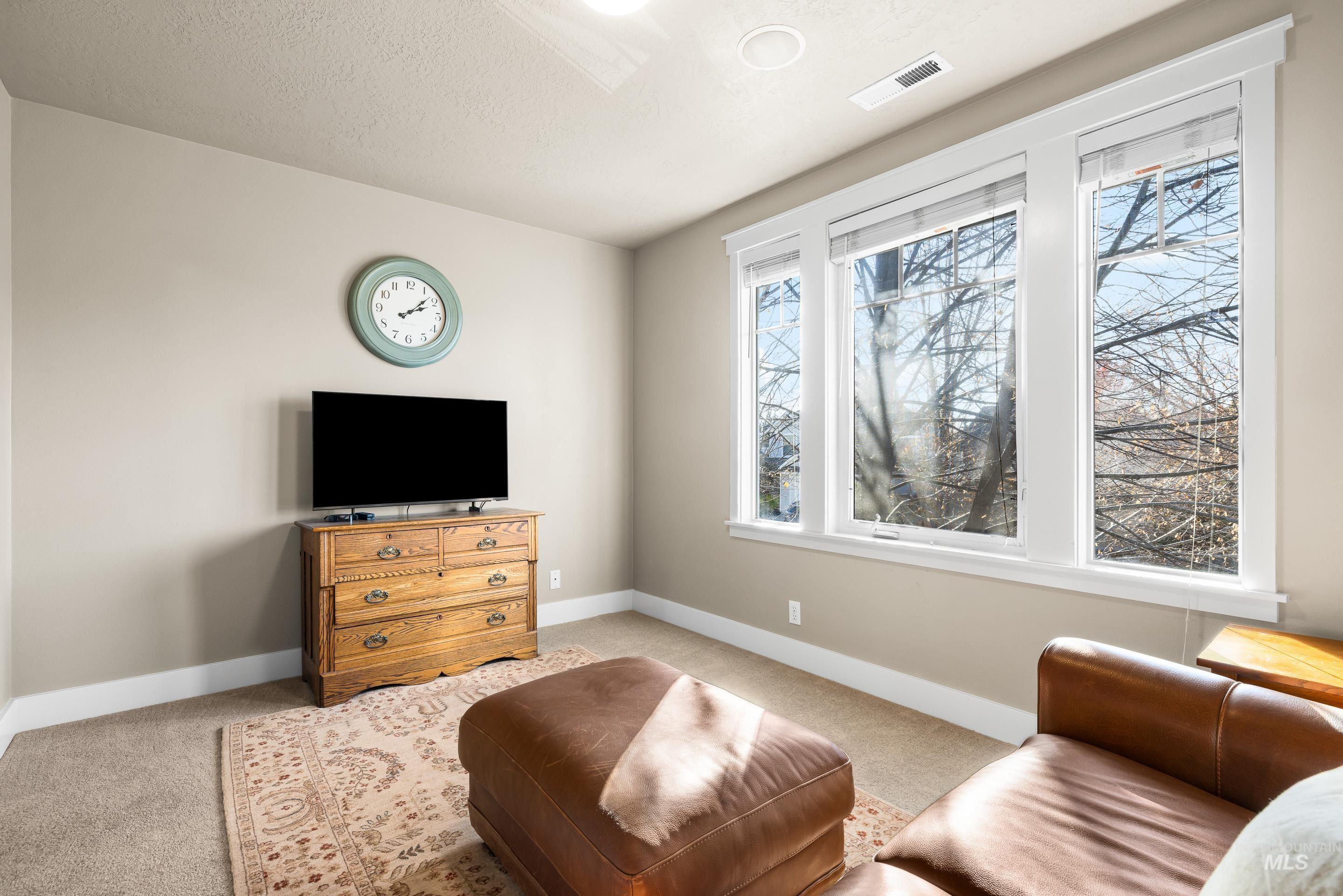 836 West Colbert Street Meridian, ID 83646 - Photo 26 of 45 Living area featuring light carpet and a textured ceiling