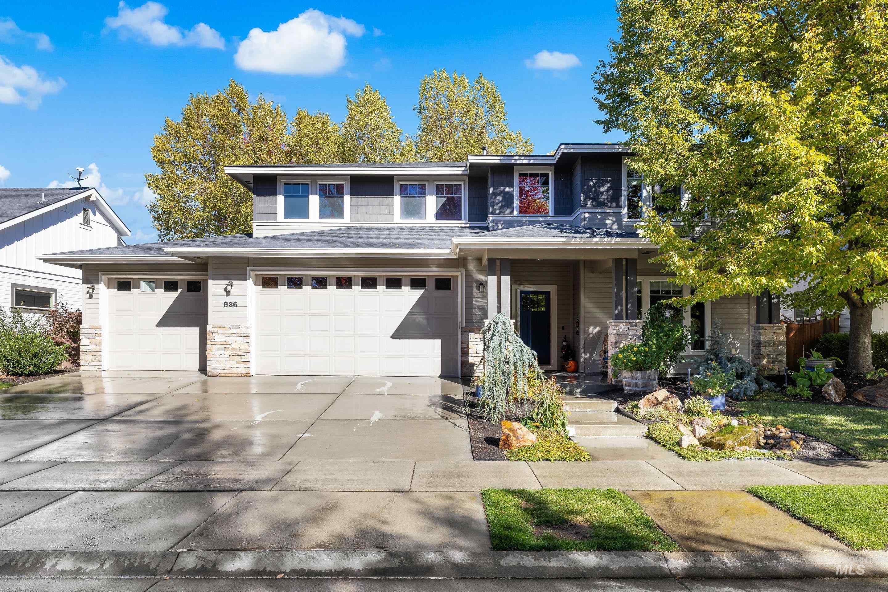 836 West Colbert Street Meridian, ID 83646 - Photo 3 of 45 Prairie-style home featuring stone siding, concrete driveway, and covered porch
