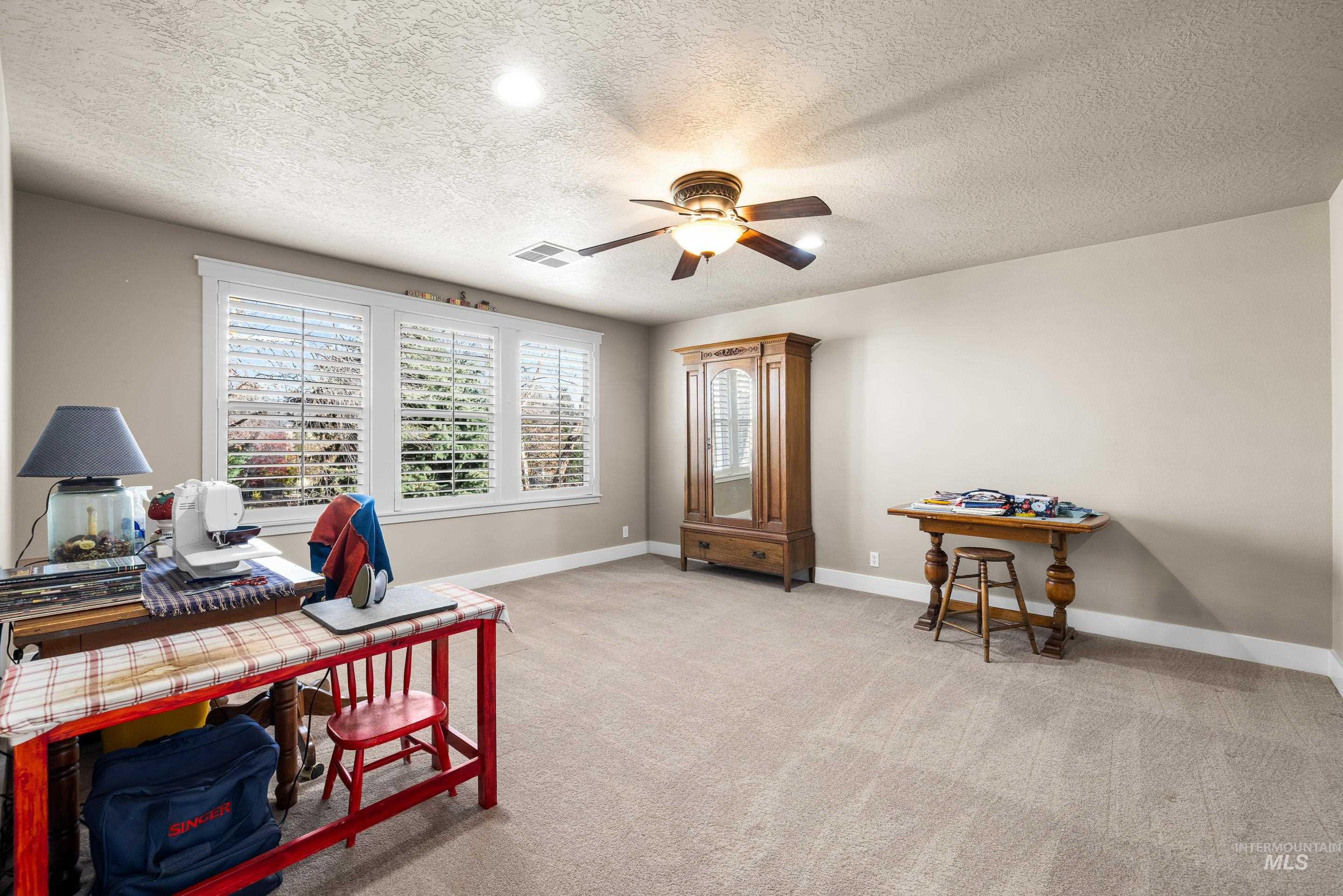836 West Colbert Street Meridian, ID 83646 - Photo 31 of 45 Office area with light carpet, a textured ceiling, and ceiling fan