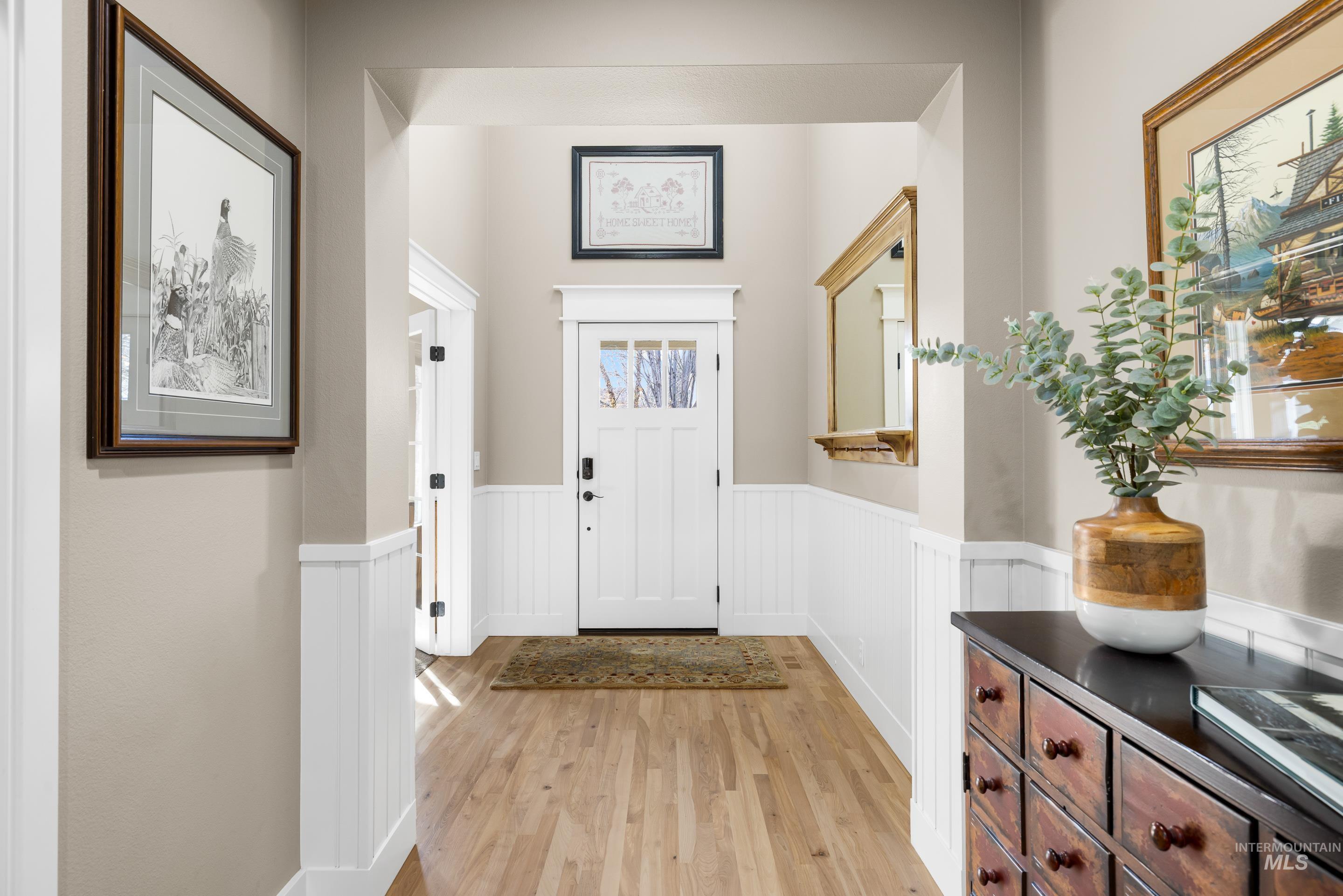 836 West Colbert Street Meridian, ID 83646 - Photo 6 of 45 Foyer featuring light wood-type flooring and wainscoting